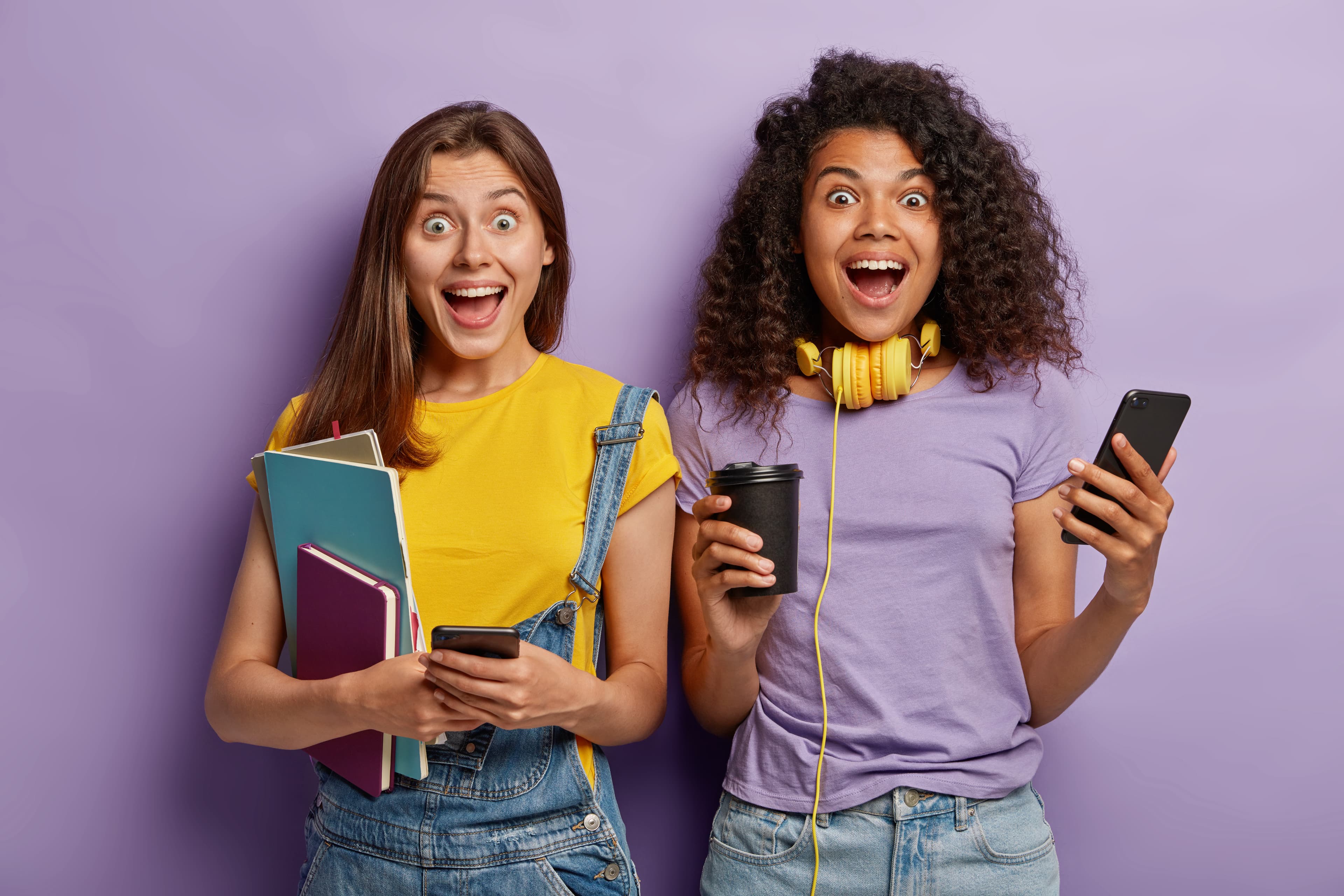 Happy friends with phones, showing students sharing campus decisions together on Kampus Connect